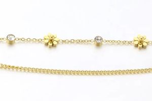Armband verguld goud met bloemen en steentjes (20 cm)